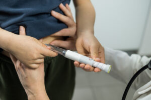 Young patient injecting
